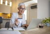 a person sitting at a table using a laptop